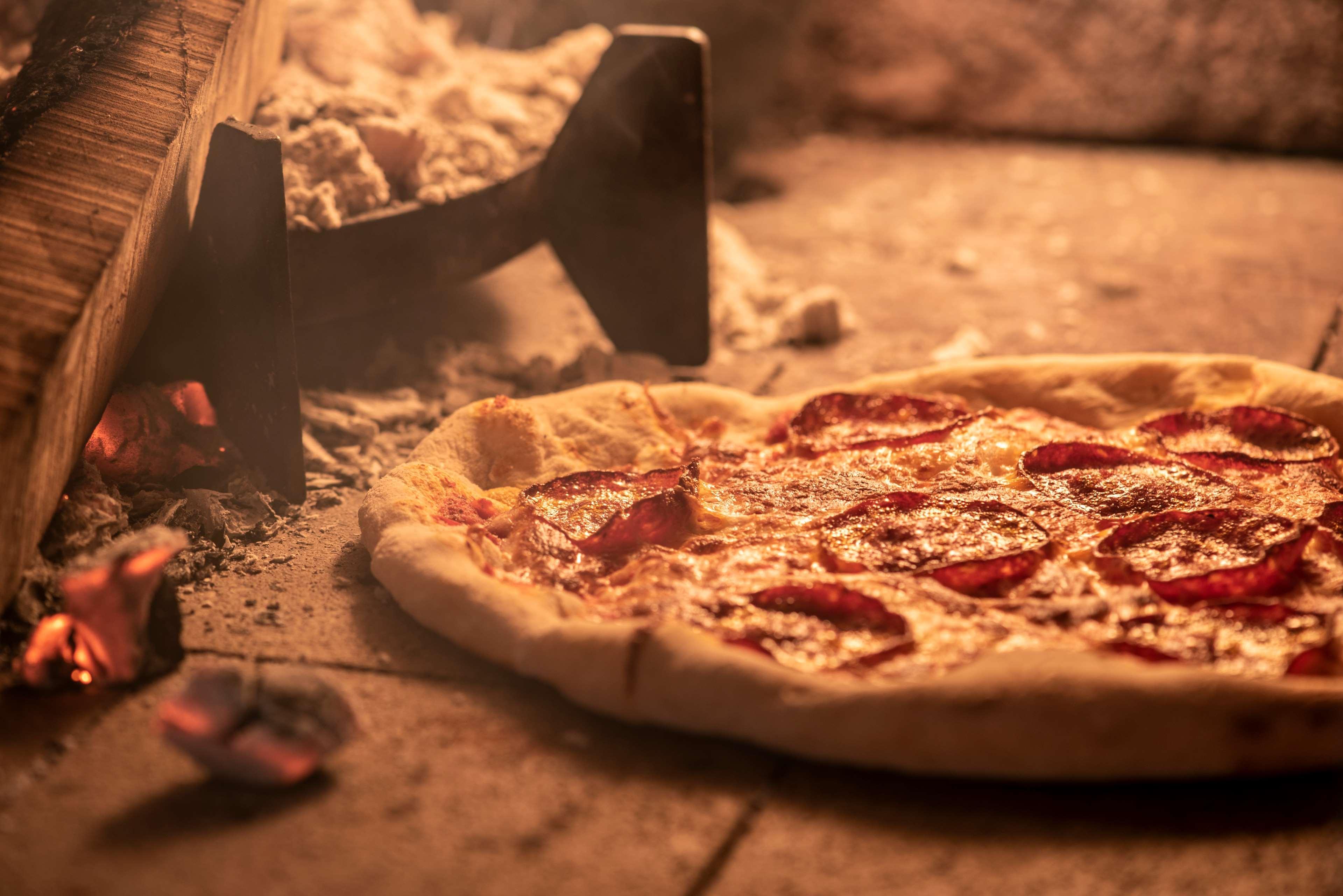 Park Hyatt Abu Dhabi Hotel&Villas Esterno foto Pizza being removed from a wood-fired oven